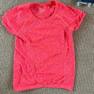 Bright neon orange pink Athleta Girl workout shirt.